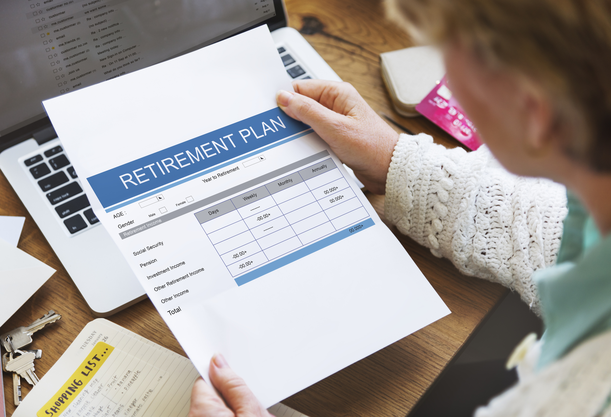 An older adult examining a document titled “retirement plan.”